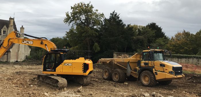 Excavator loading a dump truck on an earthworks job